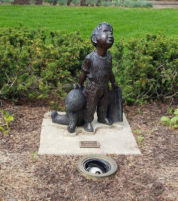 Sculpture of Little Boy with Bear and Book at Adrian Library