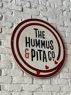 The Hummus & Pita Co sign hanging on the wall for your ur viewing pleasure!