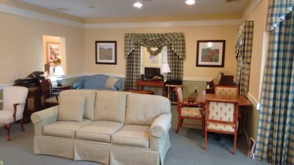 Living room with fireplace and piano.