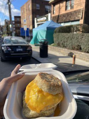 Sausage egg and cheese biscuit with teal tent in background