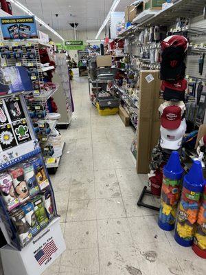 Pathway to get to the checkouts, floor is covered in filth.