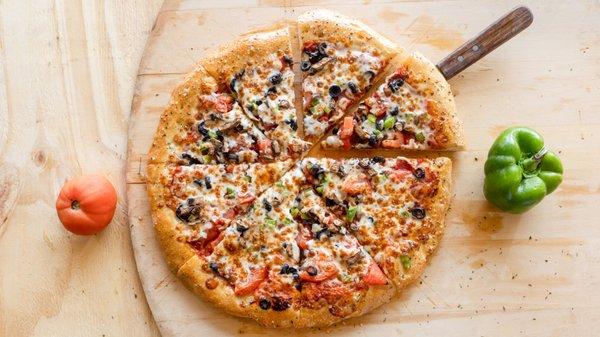 Our Veggie Pizza is topped with tomatoes, mushrooms, onions, green peppers and black olives and finely shredded Italian mozzarella cheese!