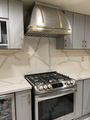 Brass ribbons and rivets adorn our stainless steel range hood.