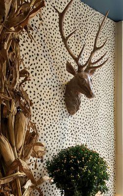 Resin deer mount with animal print wallcovering from Thibaut.