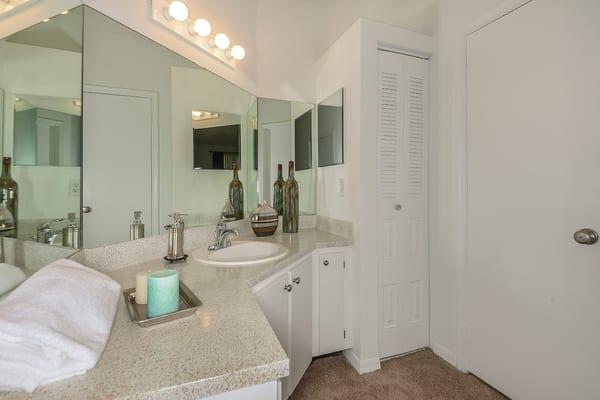 Bathrooms have plenty of cabinet space and a linen closet