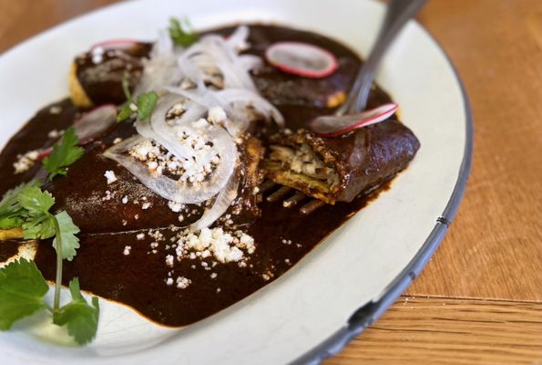 Enchiladas de Mole Negro con Pollo: Chicken enchiladas, mole negro, queso fresco ($20)