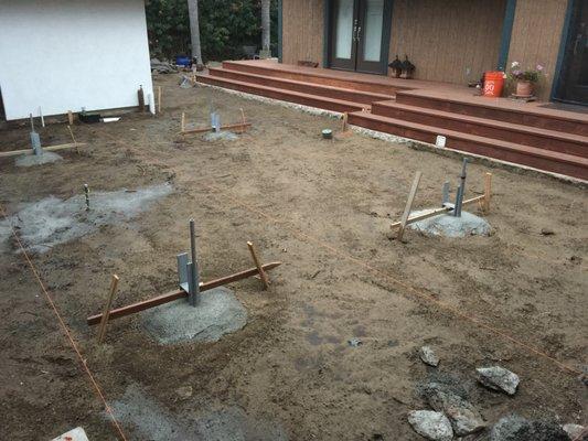 Allowing the concrete to set around the stakes for future pavilion and outdoor patio living area.