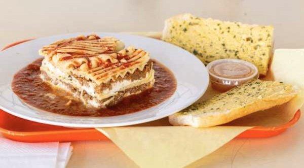 Lasagna served with meat sauce and garlic bread