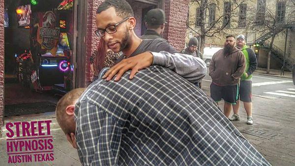 For obvious reasons I can not share pictures of me doing client work. Here is me doing fun (street) hypnosis on 6th street in Austin, TX.