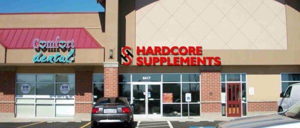 The front of the store. To the right is Moon's Mongolian Grill and to the left is Comfort Dental and The Man Shop.