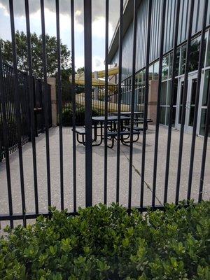 Fenced in picnic area outside of the indoor pool.