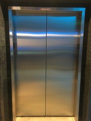 Cladded Stainless Steel Over Bronze Elevator Entrance