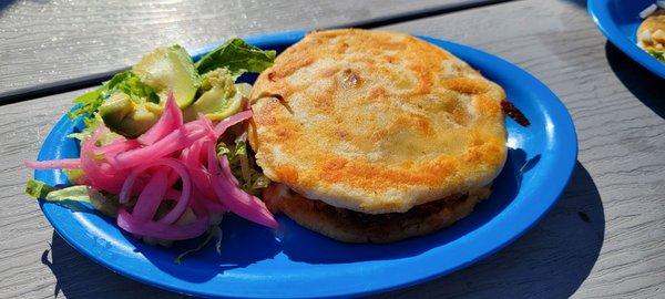 Gordita with carnitas and fixings (onion, cilantro, avocado, lettuce)