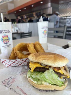 Cheeseburger with grilled onions and onion rings