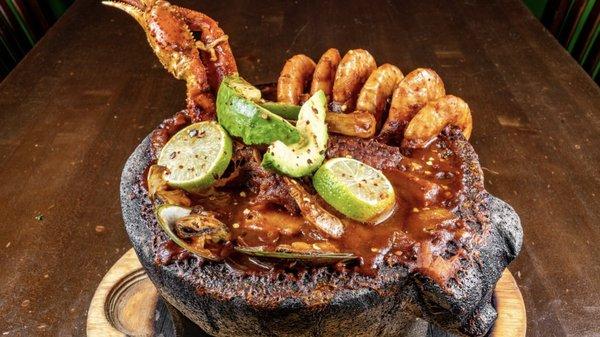 Molcajete Levanta Muertos. Our signature heat- mortar is filled to the brim with seasoned scallops, fried shrimp, clams, fish, and snow crab