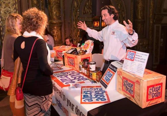 Owner Tom Connors explaining the different items Syracuse Crate handles at the 2014 Buy Local Bash at Syracuse's Landmark Theater.