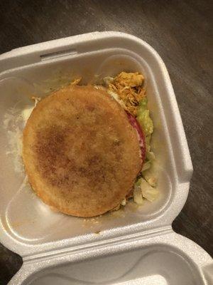 imagine an arepa left for a week in the trunk of a car then smother it with cheap sauce .