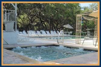 The hot tub is next to the pool, and overlooks the little lake.