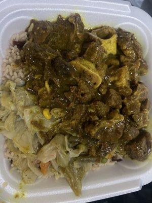 Curry Goat with cabbage rice and peas