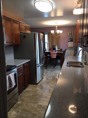 New kitchen cabinets, countertops, and tile floors