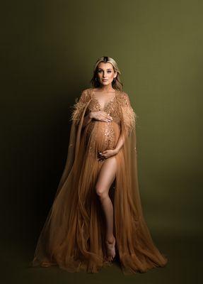 A maternity portrait in one of the gowns offered by NicSo Studio