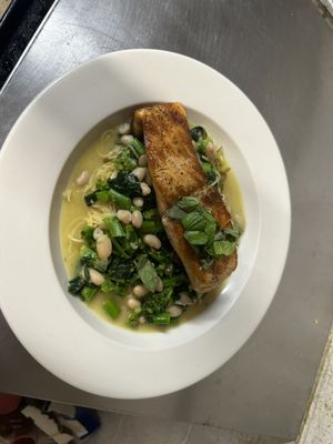 Salmon with broccoli rabe and beans in a garlic white wine sauce