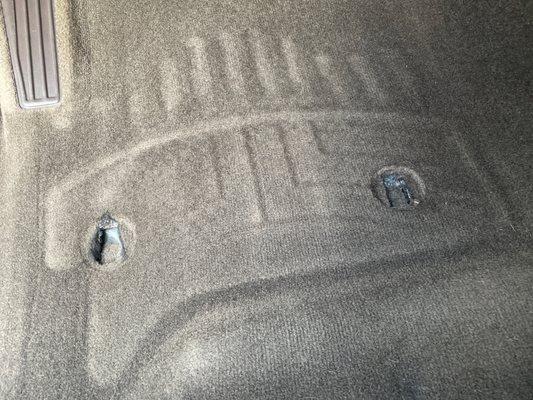 Holes in carpet where plastic clips were previously. They pulled so hard they tore the carpet making it impossible for the clips to attach.