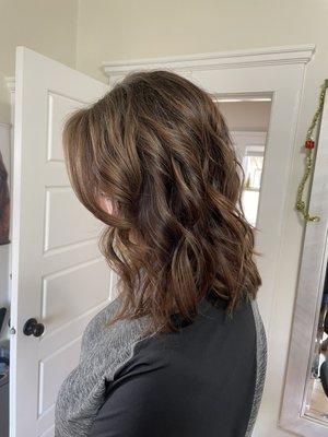 Rich warm brunette with Carmel teasylights creating a flattering lived-in look.