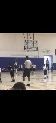 An OMG Camper scoring a layup in her game.