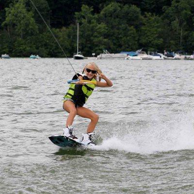 Cool shot of a girl wakeboarding with her lakeside watersports sunglasses