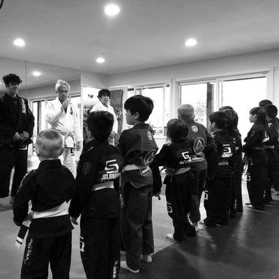 Sleeper Kids lining up to end class, bow out and shake hands after a successful day of training.