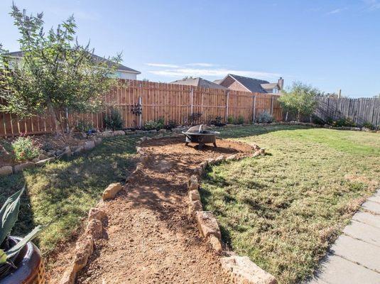 Fire pit and landscape in the back