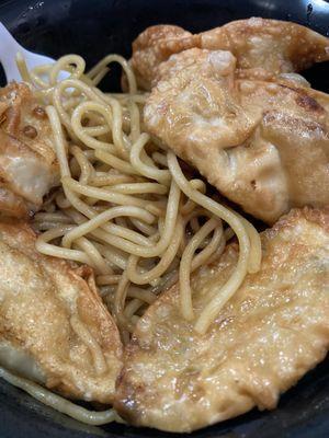 Dry garlic noodles with pot stickers.