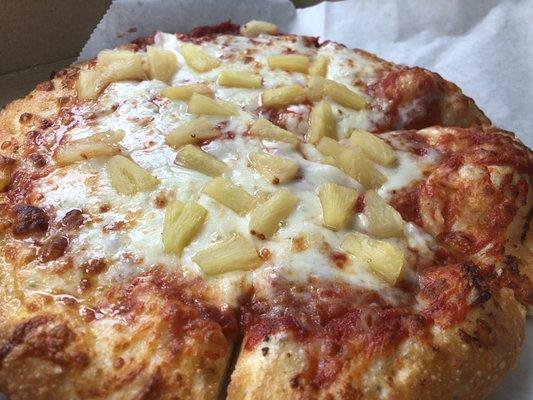 Personal pineapple pizza with garlic butter crust.