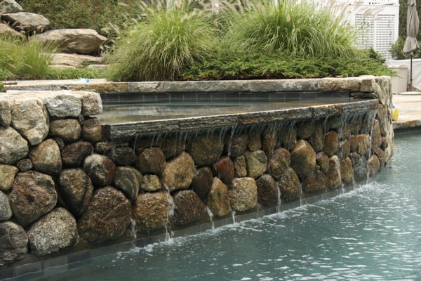 Relaxing pool waterfall with natural fieldstone.