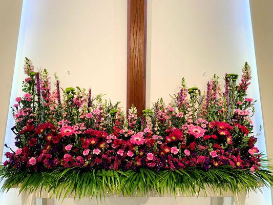 Fresh flowers arranged weekly adorn the sanctuary