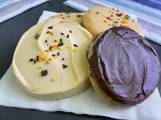 Glazed sugar, large sugar w/buttercream, & a double frosted peanut butter cookie.