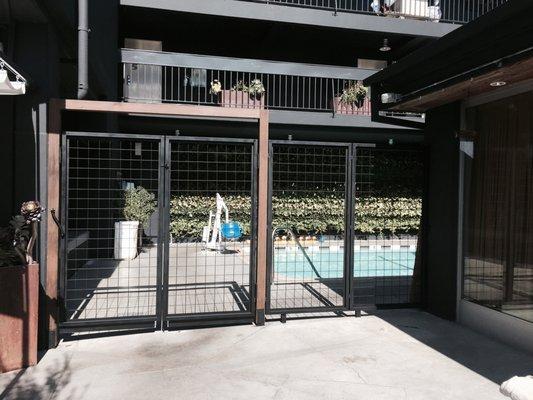 Pool Gate, metal mesh with steel frame and Cedar wood arch.