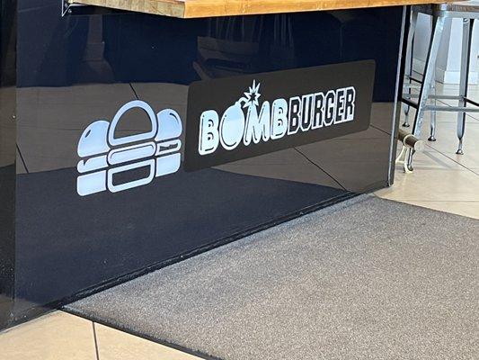 Bomb Burger under register signage