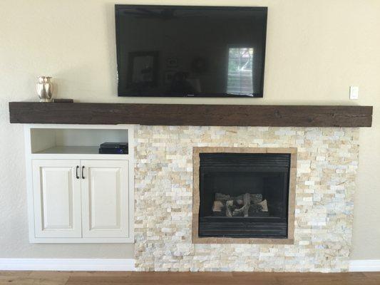 Fire place and entertainment with wood rail mantel