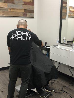 John Khut in the middle of a haircut, wearing his new business shirt.