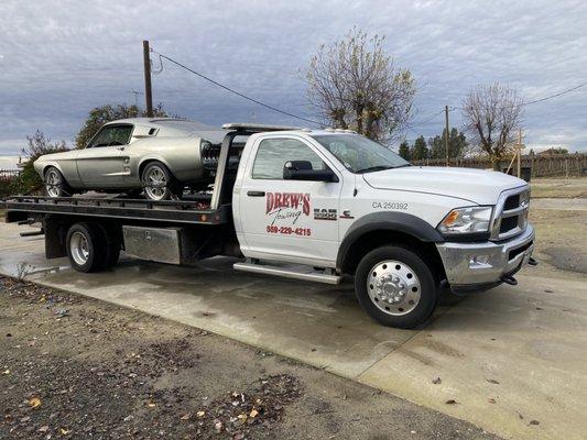 Drews Towing servicing a Fastback Mustang.