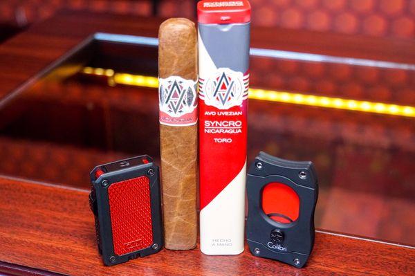 The Syncro by Avo Cigars, Rally single-jet flame lighter and S Cut cutter with red color blades by Colibri available at Broadway Cigar.