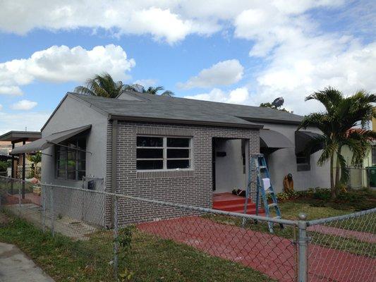 The after picture of a home we did a full exterior remodel of, including roofing, door, windows, and brick!