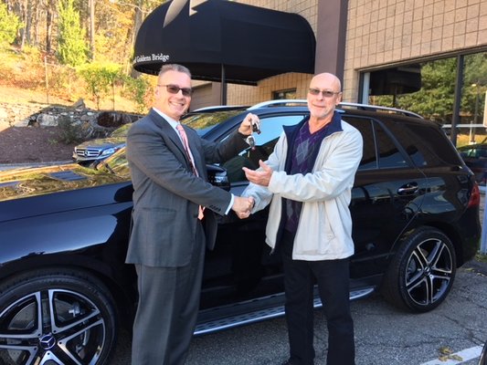 Victor Varga shaking hands and handing off the keys to his new client who purchased a 2018 GLE-43 AMG. congratulations!