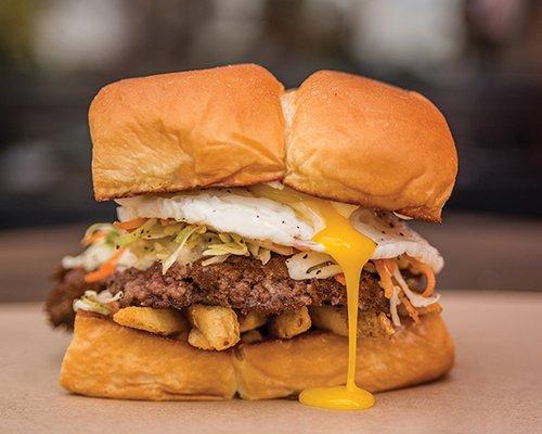 THE FREIBURGER® – white american cheese, fries, haus slaw, fried egg, mayo