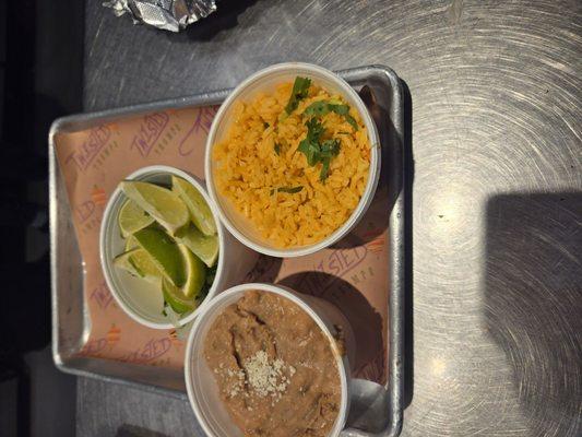 Side of rice, pinto beans,  and lime