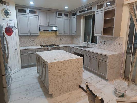 Kitchen countertop installation full backsplash and waterfall on island and counter.