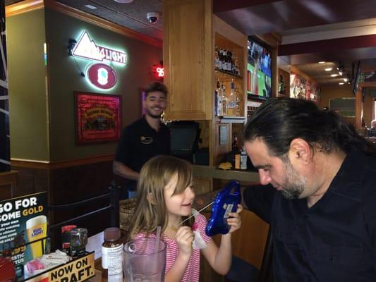 Our server, Brandon in the background and my happy Niece in the foreground. He made sure her order was in quick and kept us all happy.