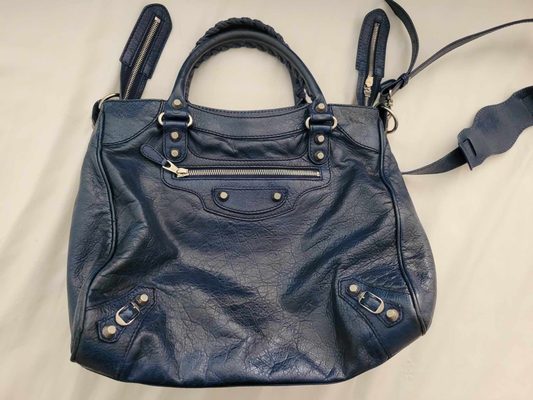 Balenciaga bag. It was horribly scuffed and scratched, he returned it to like-new condition.